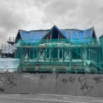 Structural steel frame and façade under construction on a London development, illustrating construction interface coordination between structure and envelope